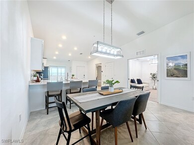 Tiled dining space featuring lofted ceiling