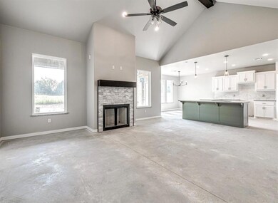 Unfurnished living room featuring beamed ceiling, 