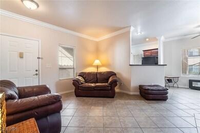 Living area featuring baseboards, crown molding, a