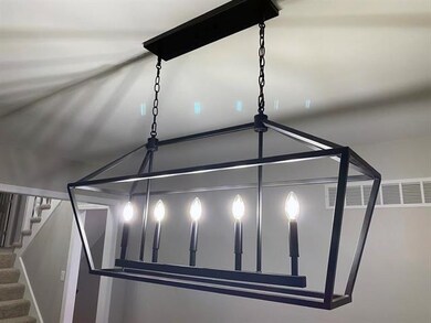 Linear statement chandelier accents the dining spa