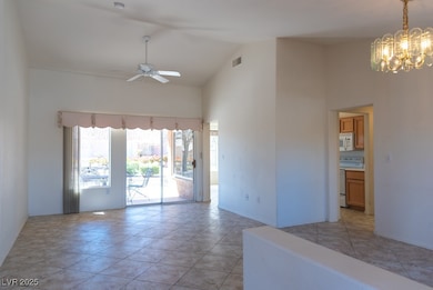 Entryway to living and dining room, high vaulted c