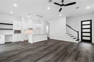 A spacious living area filled with natural light, designed with clean lines and an open concept that easily connects to the kitchen, perfect for entertaining or relaxing.