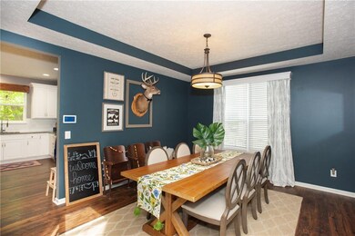 Stunning dining room with tray ceiling.
