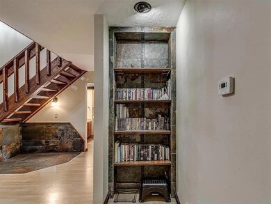 Stairway with wood-type flooring and built in shel
