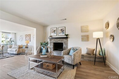 Living room with cozy stone fireplace.