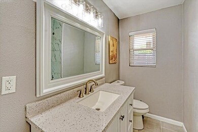 Bathroom featuring baseboards, toilet, vanity, a t
