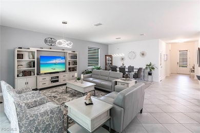 Living room with a chandelier and light tile patterned floors