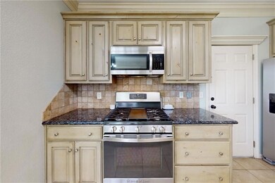Kitchen with crown molding, appliances with stainl