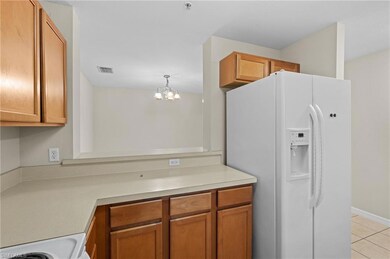 Kitchen with light tile patterned floors, range, h