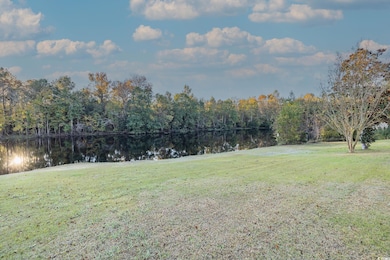 View of green lawn with a water view