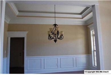 Dining room with extensive moldings, tray ceiling and rope lighting