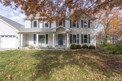 Traditional-style house featuring covered porch, a front lawn, and roof with shingles