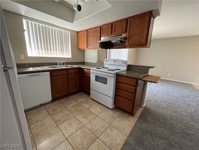 Kitchen featuring white appliances, under cabinet