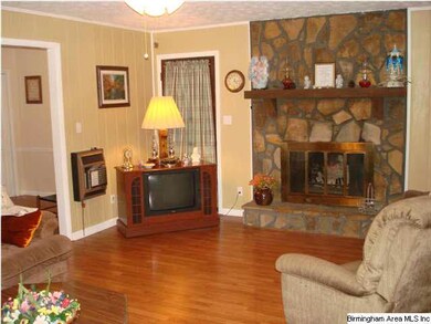 Spacious Den With Rock Fireplace And Laminate Hard