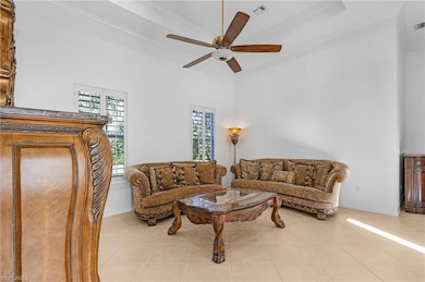 Tiled living room with ornamental molding and ceil