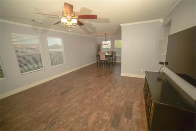 Living room and dining room have wood look tile floors. All of the first floor has the same treatment.