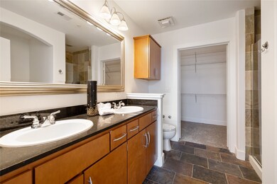 Dual sinks with sleek marble countertops.