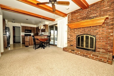 Beamed ceilings, fireplace, this familyroom over l