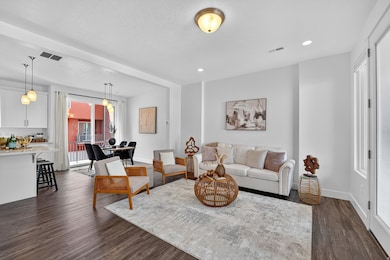 Living area with dark wood finished floors, recessed lighting, and a textured ceiling