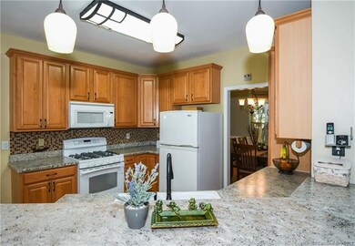 Updated kitchen with granite laminate, tile backsplash and gas range