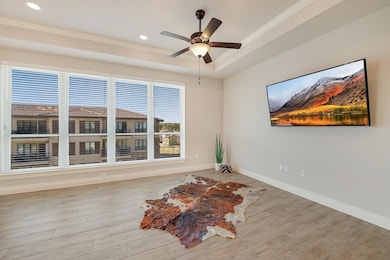 Spare room featuring a ceiling fan, wood finished