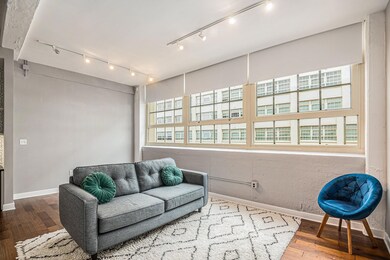 Living room with hardwood / wood-style floors and 