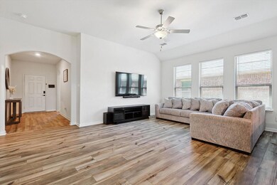 Living room featuring wood-type flooring and ceiling fan