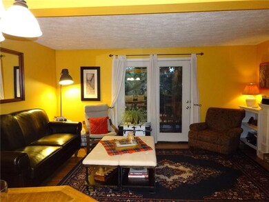 Living Room with Oak Hardwood Floors and Glass Doo