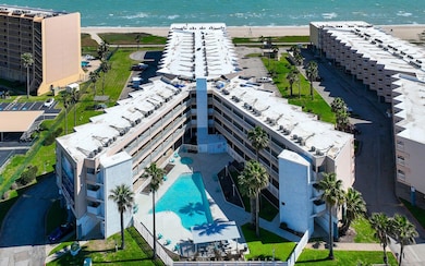 Aerial view of a pool area and expansive coastline