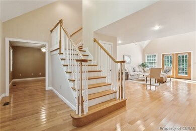Stairs with ceiling fan, light hardwood / wood-sty