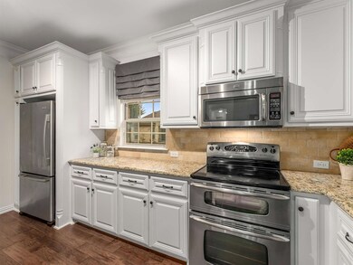 The kitchen showcases granite countertops, painted