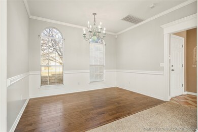 Formal Dining with crown moulding and wainscoting.