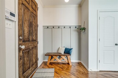Mudroom featuring wood finished floors, baseboards