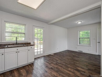 Window at kitchen sink offers views of old Oaks an