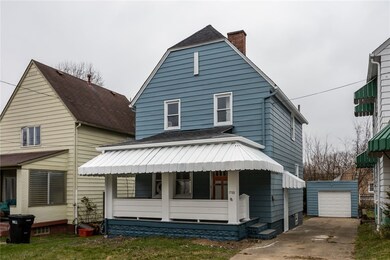 Front with driveway to detached garage