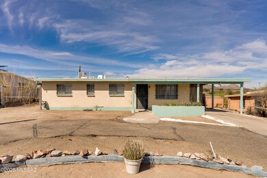 Front, car port and circular driveway.