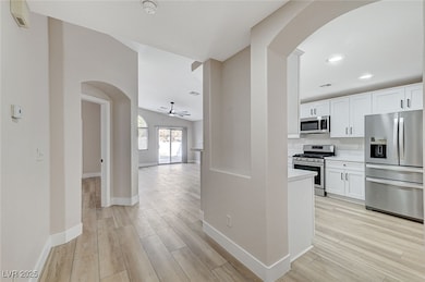 Kitchen with stainless steel appliances, arched wa
