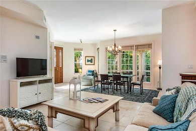 Living room with light tile patterned floors and a