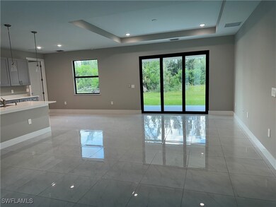 Unfurnished room with light tile patterned flooring and a raised ceiling