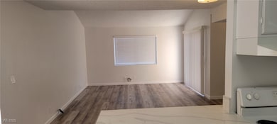 Unfurnished bedroom with wood finished floors and