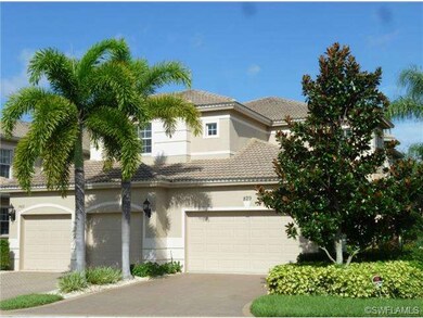 Coach home with 2-car garage and lush landscaping