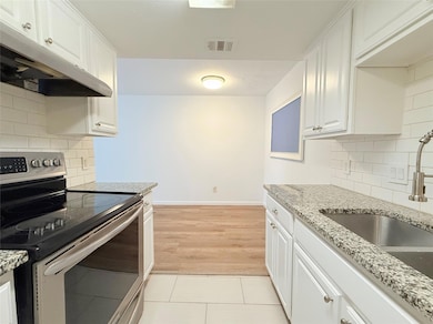 Kitchen with stainless steel range with electric 