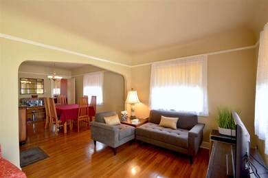 Living room leads to the formal dining room.