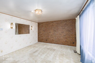 Carpeted spare room with wallpapered walls