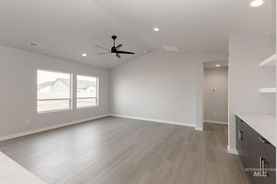 Unfurnished living room featuring lofted ceiling, light wood finished floors, recessed lighting, and a ceiling fan