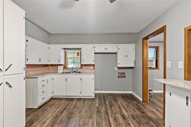 Kitchen featuring cooling unit, white cabinets, wo