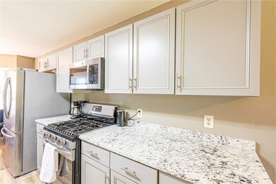 Equipped with high-end stainless steel appliances, including a 5-burner gas range, cooking becomes a joyous experience.