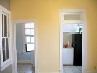 Spacious bathroom on the left with window. Kitchen