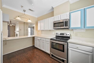 Kitchen with light countertops, hanging light fixt
