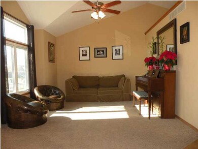 Vaulted living room open to dining/kitchen area